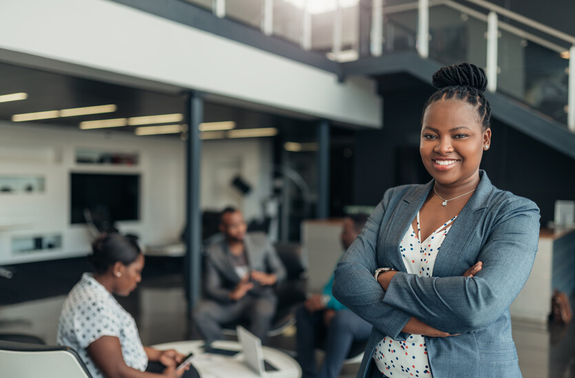 A young Black professional poses at work