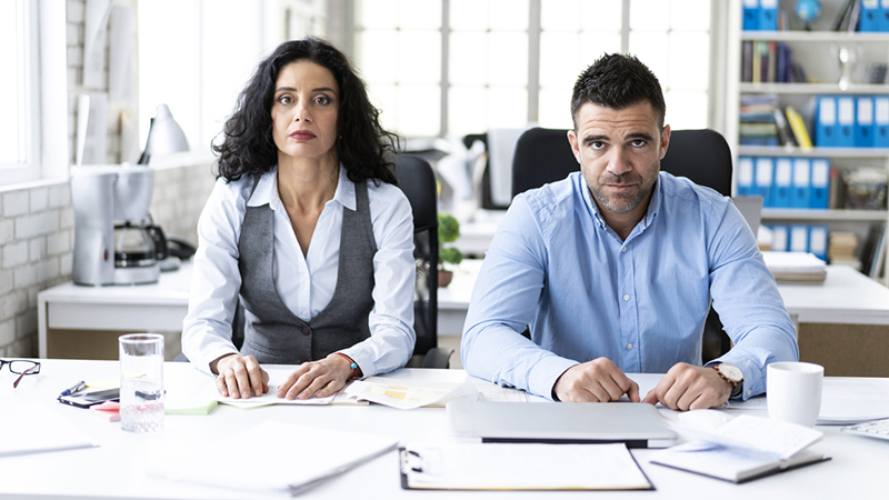 Photo of two people working in an office together